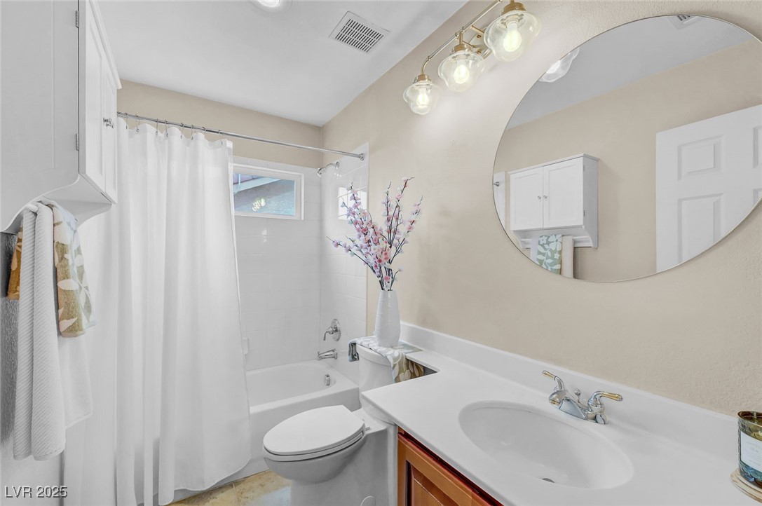 9725 Sandy Turtle Avenue Las Vegas, NV 89149 - Photo 40 of 51 Bathroom with shower / bath combination with curtain and vanity