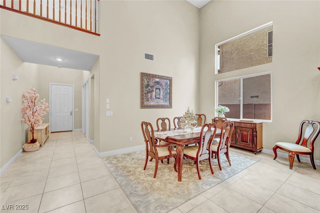 9725 Sandy Turtle Avenue Las Vegas, NV 89149 - Photo 4 of 51 Dining area featuring a high ceiling and light tile patterned floors