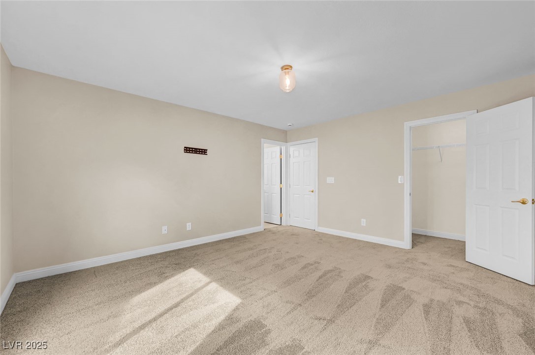 9725 Sandy Turtle Avenue Las Vegas, NV 89149 - Photo 44 of 51 Unfurnished bedroom featuring light carpet and a spacious closet