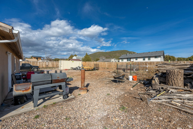 348 North Lodge Road Central, UT 84722 - Photo 14 of 25 Fenced backyard with a patio area and a mountain view