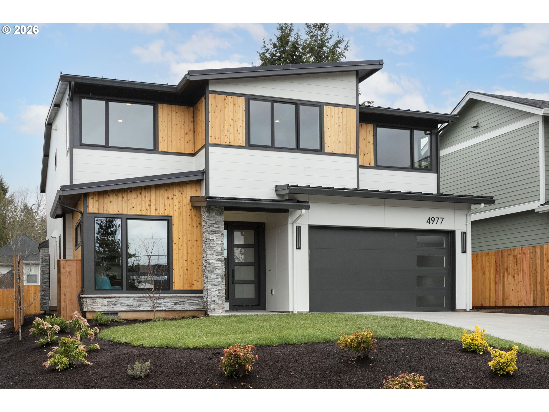4977 Summit Street West Linn, OR 97068 - Photo 2 of 43 a front view of a house with a yard and garage
