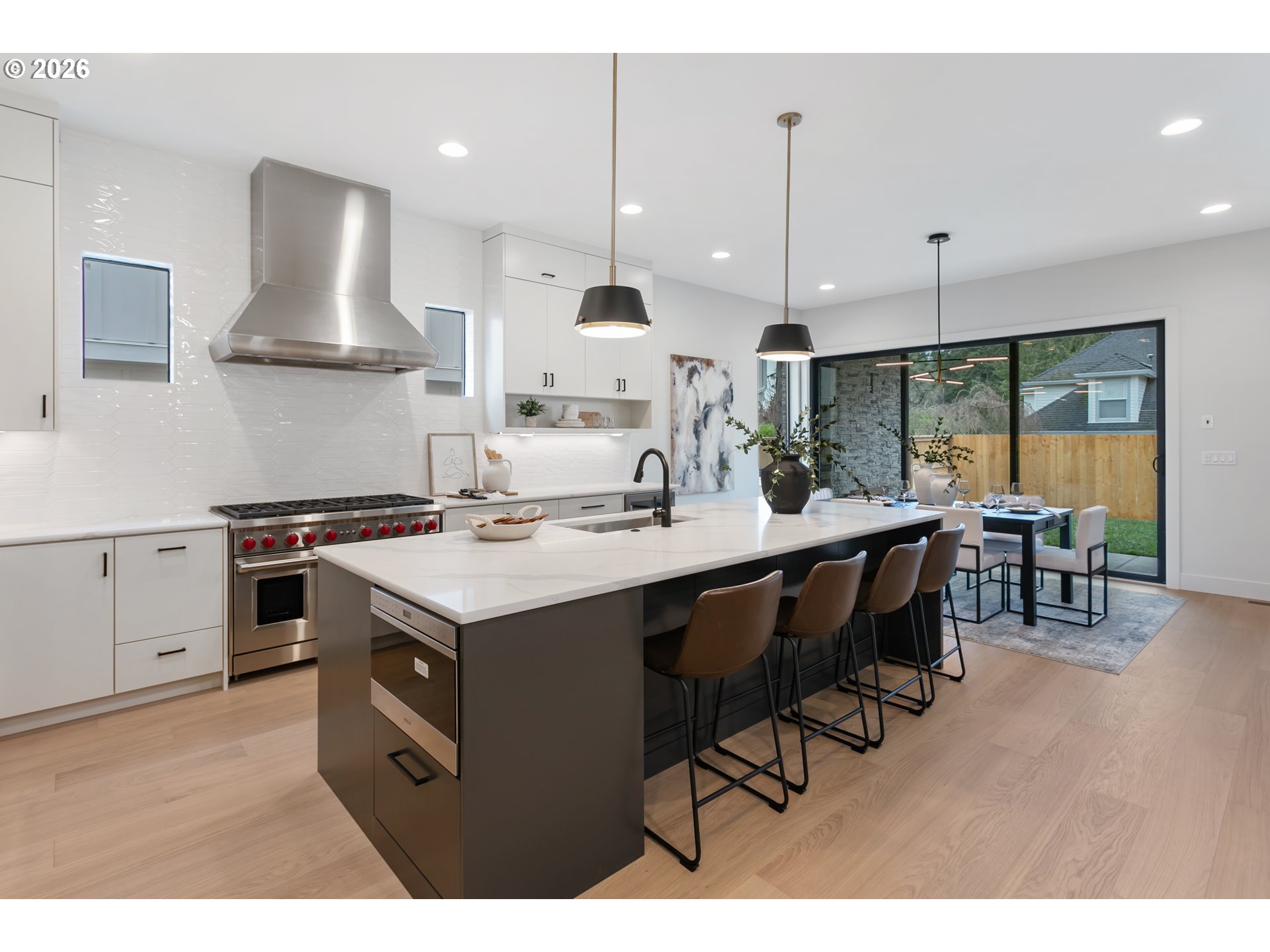 4977 Summit Street West Linn, OR 97068 - Photo 6 of 43 a kitchen with kitchen island a stove a table and chairs in it
