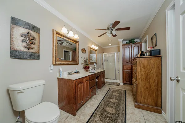 a bathroom with a double vanity sink toilet and shower