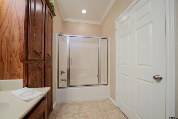 a bathroom with a granite countertop sink and shower