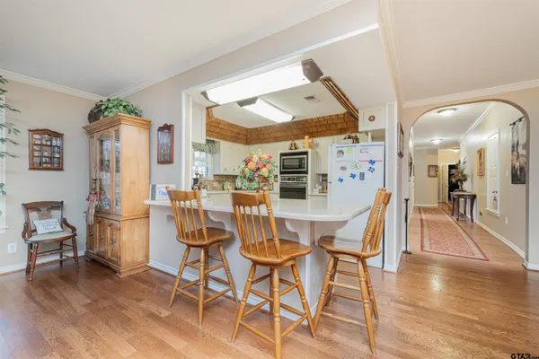 a dining room with furniture and wooden floor