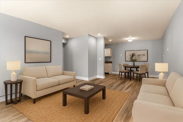 a living room with furniture and wooden floor