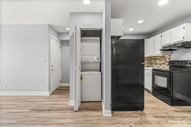 a view of a kitchen with a refrigerator and cabinets