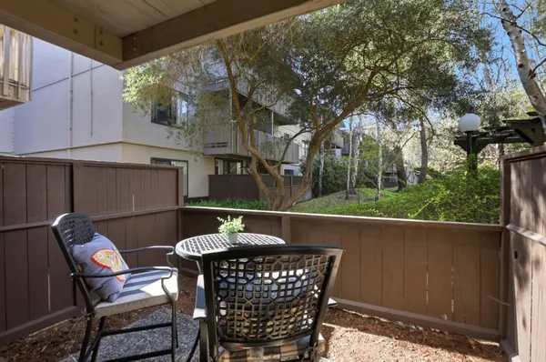 a view of a chair and table in the patio