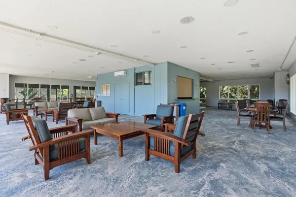 a living room with furniture and a floor to ceiling window