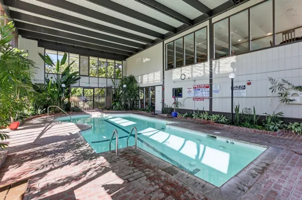 a view of swimming pool with sitting area and garden