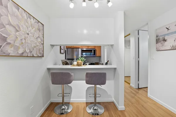 a bedroom with a bed and a painting on the wall