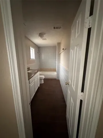 a view of a hallway with windows