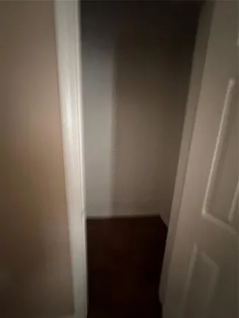 a hallway with sliding door and front door
