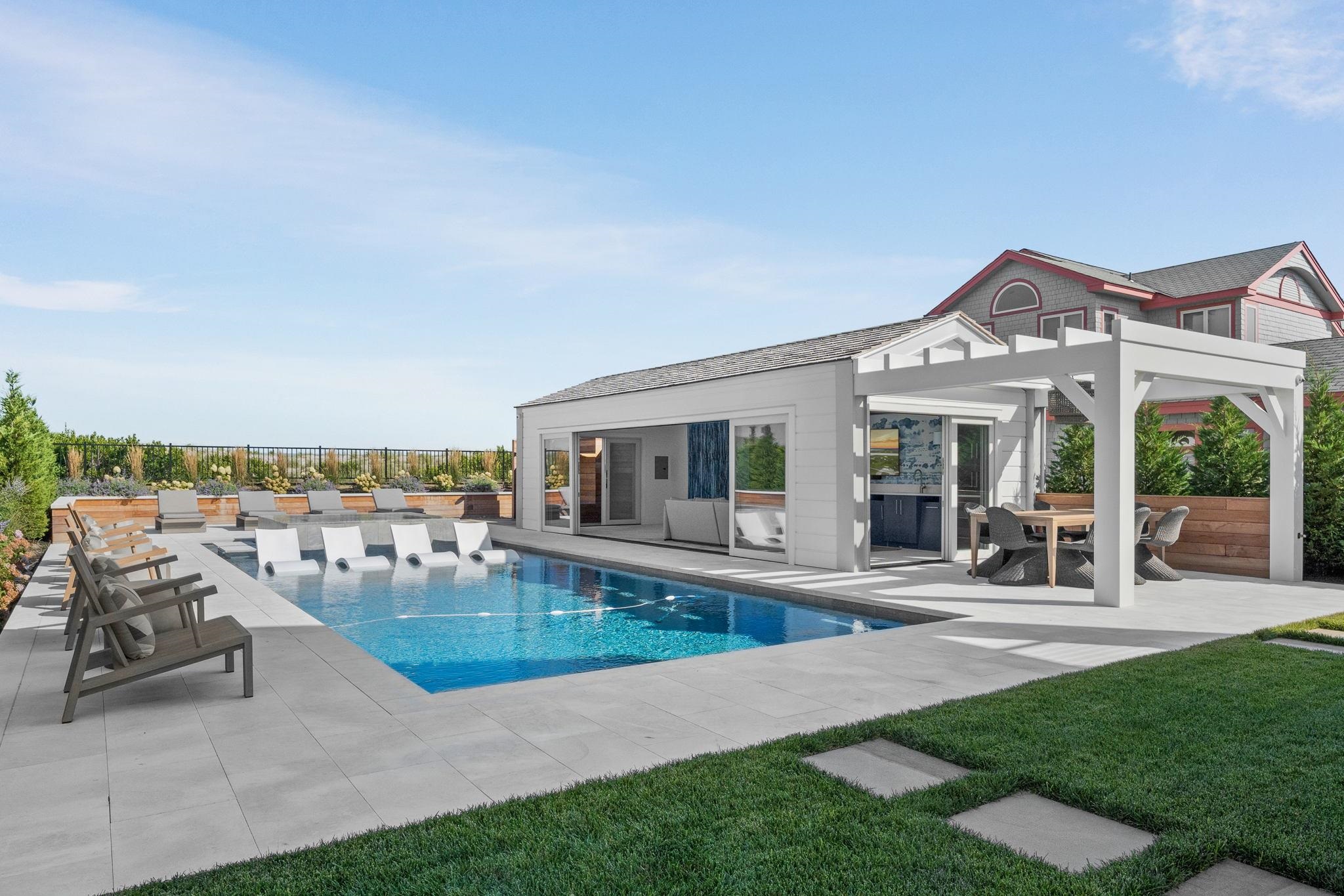 8808 1st Avenue Stone Harbor, NJ 08247 - Photo 16 of 49 a view of a house with a lounge chairs in a patio