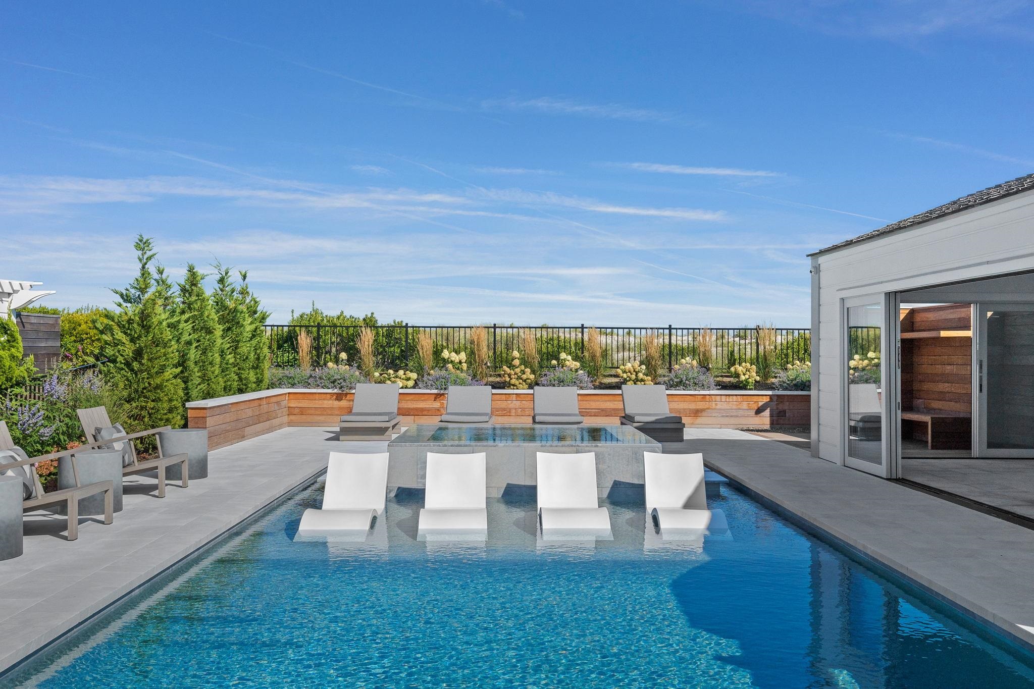 8808 1st Avenue Stone Harbor, NJ 08247 - Photo 18 of 49 a living room with couches a coffee table and chairs with outer view