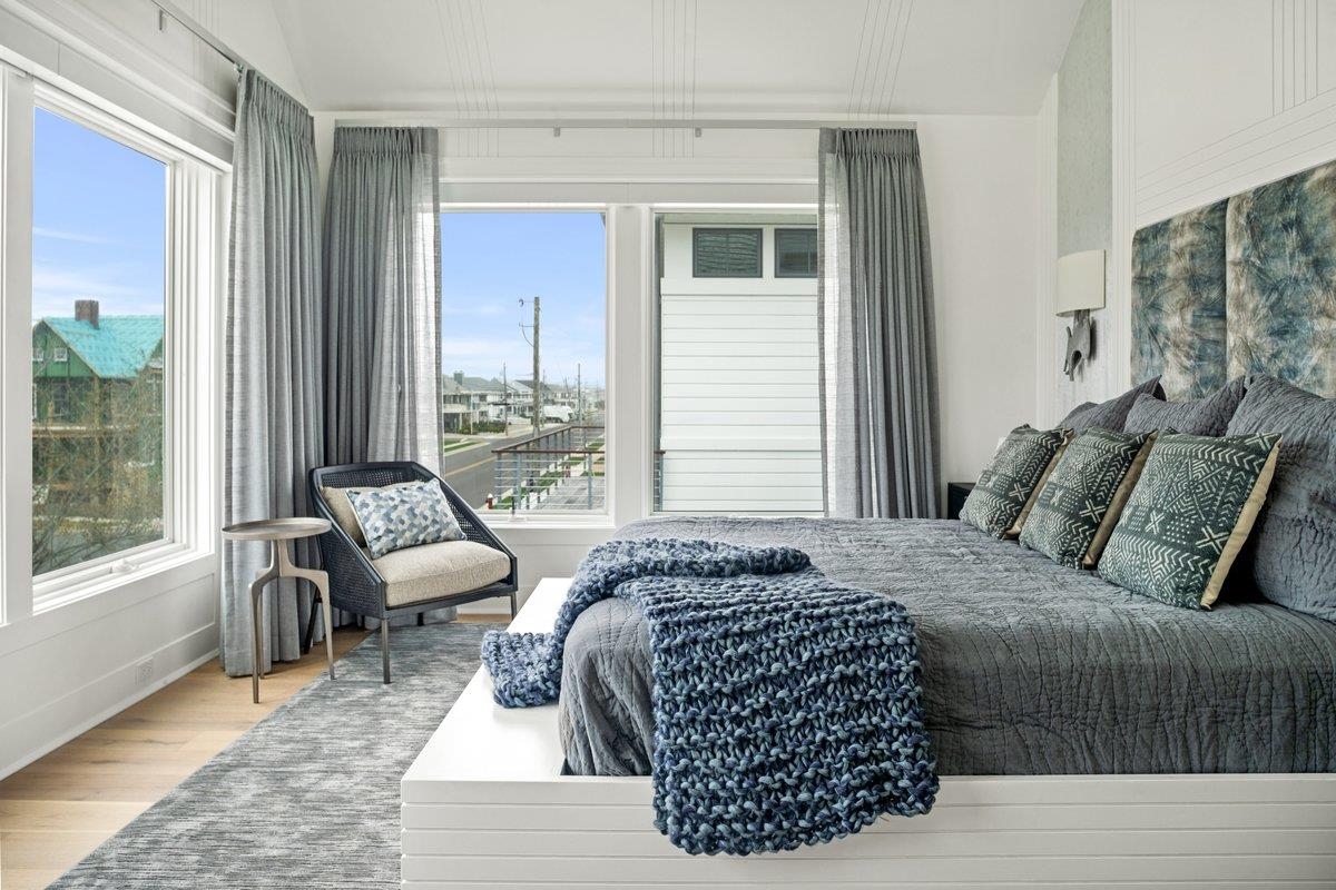 8808 1st Avenue Stone Harbor, NJ 08247 - Photo 23 of 49 a bedroom with a bed and glass window