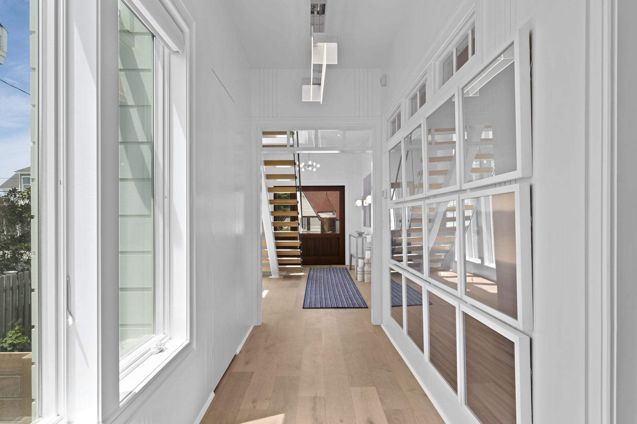 8808 1st Avenue Stone Harbor, NJ 08247 - Photo 28 of 49 a view of a hallway with wooden floor and windows