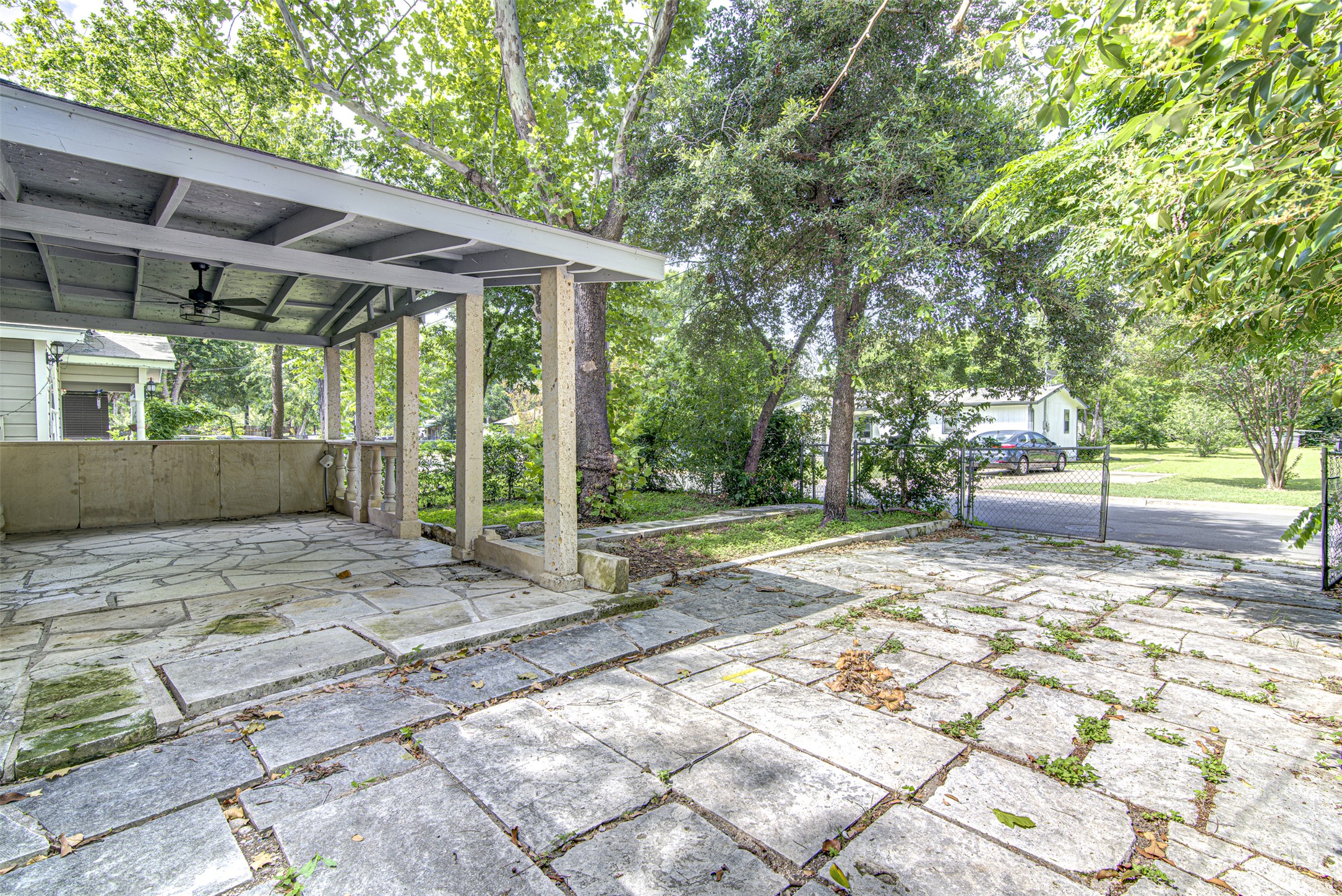 1807 San Jose Street Georgetown, TX 78626 - Photo 21 of 21 An inviting stone patio beneath a covered porch offers a serene outdoor retreat.