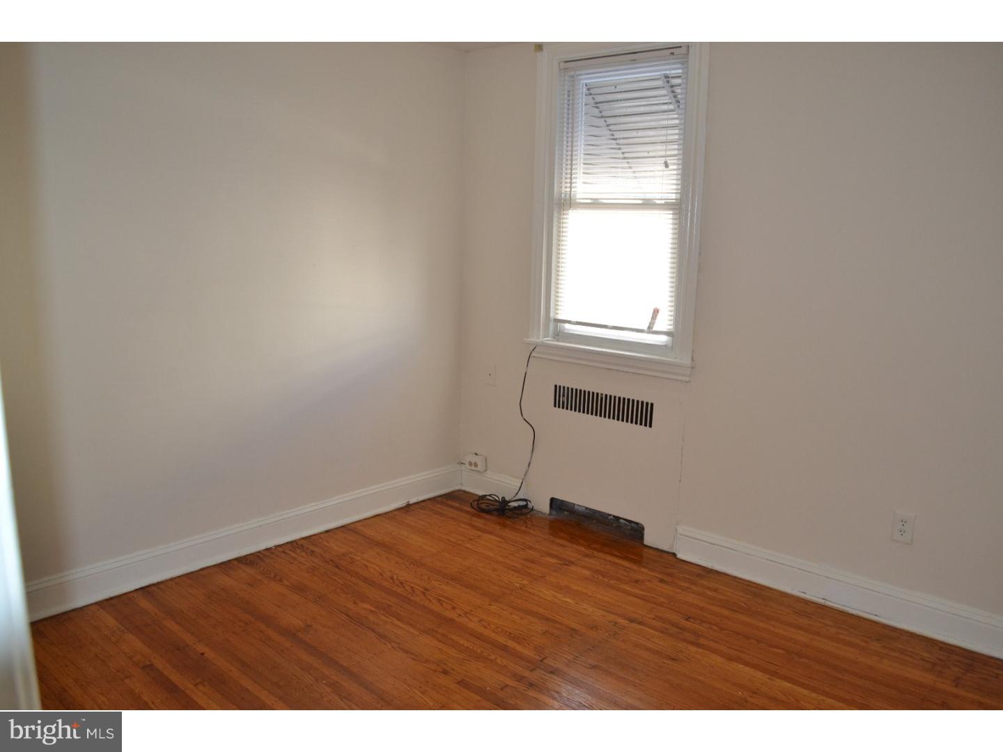 518 Timberlake Road Upper Darby, PA 19082 - Photo 14 of 21 a view of an empty room with wooden floor and a window