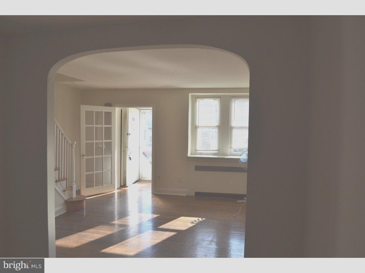 518 Timberlake Road Upper Darby, PA 19082 - Photo 6 of 21 a view of a hallway with wooden floor and a living room
