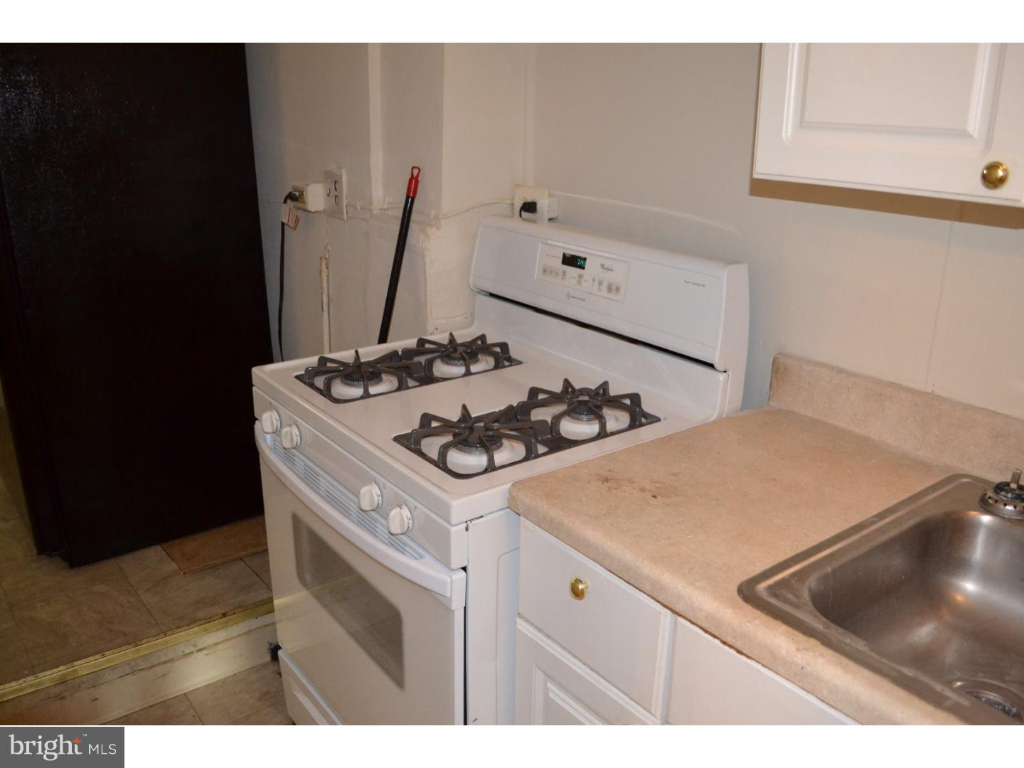 518 Timberlake Road Upper Darby, PA 19082 - Photo 8 of 21 a kitchen with a stove and a refrigerator