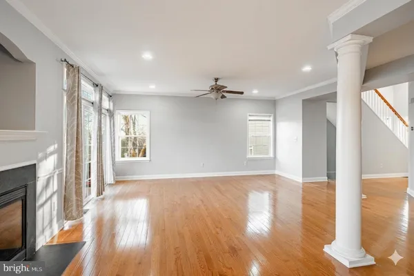a view of a living room with fireplace furniture and a large window