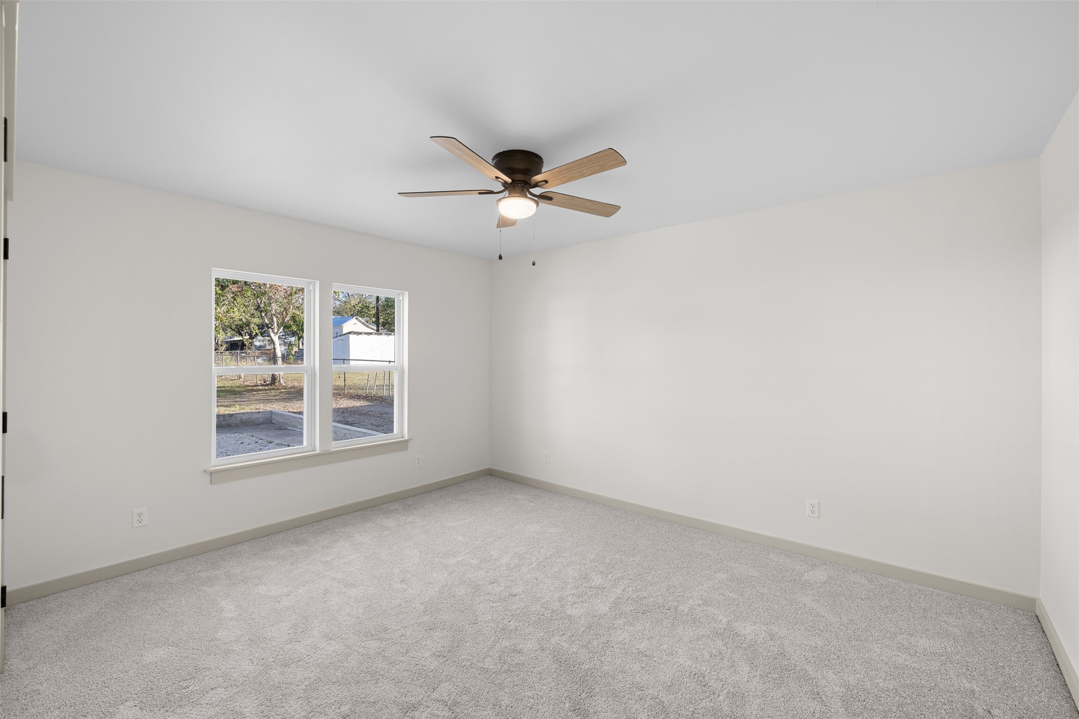 911 Eilers Street Schulenburg, TX 78956 - Photo 15 of 22 an empty room with fan and windows