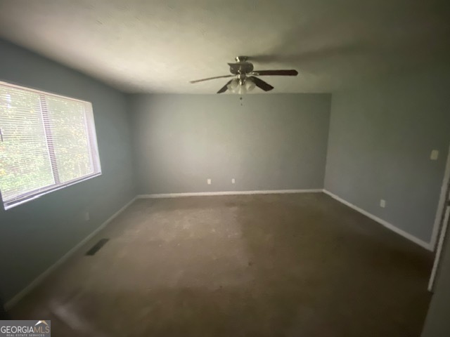 5389 Martins Crossing Road Stone Mountain, GA 30088 - Photo 15 of 30 an empty room with a window and a fan