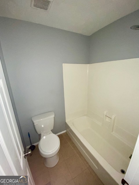 5389 Martins Crossing Road Stone Mountain, GA 30088 - Photo 18 of 30 a white toilet sitting next to a bath tub