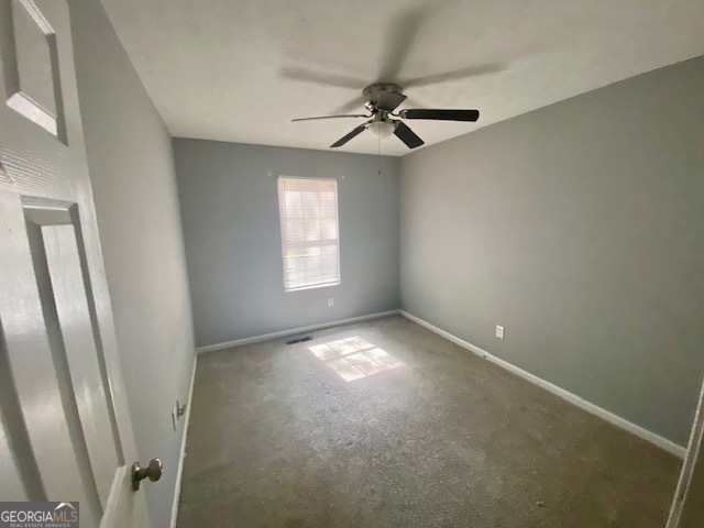 5389 Martins Crossing Road Stone Mountain, GA 30088 - Photo 19 of 30 an empty room with windows and fan