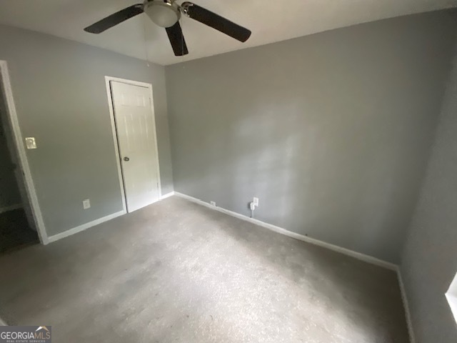 5389 Martins Crossing Road Stone Mountain, GA 30088 - Photo 20 of 30 an empty room with a ceiling fan and carpet