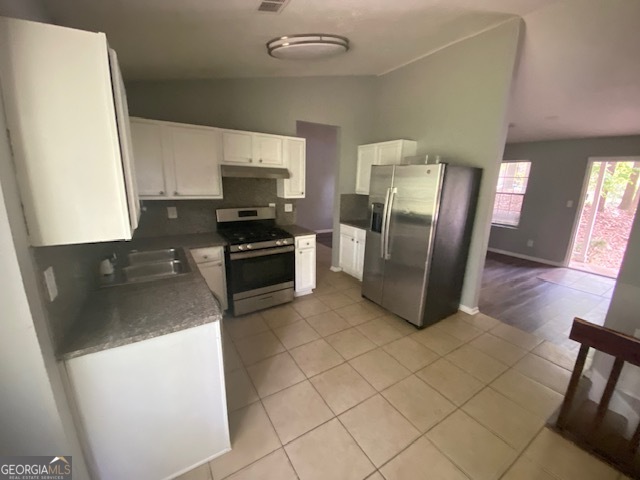 5389 Martins Crossing Road Stone Mountain, GA 30088 - Photo 8 of 30 a kitchen with stainless steel appliances granite countertop a refrigerator a stove top oven a sink and dishwasher