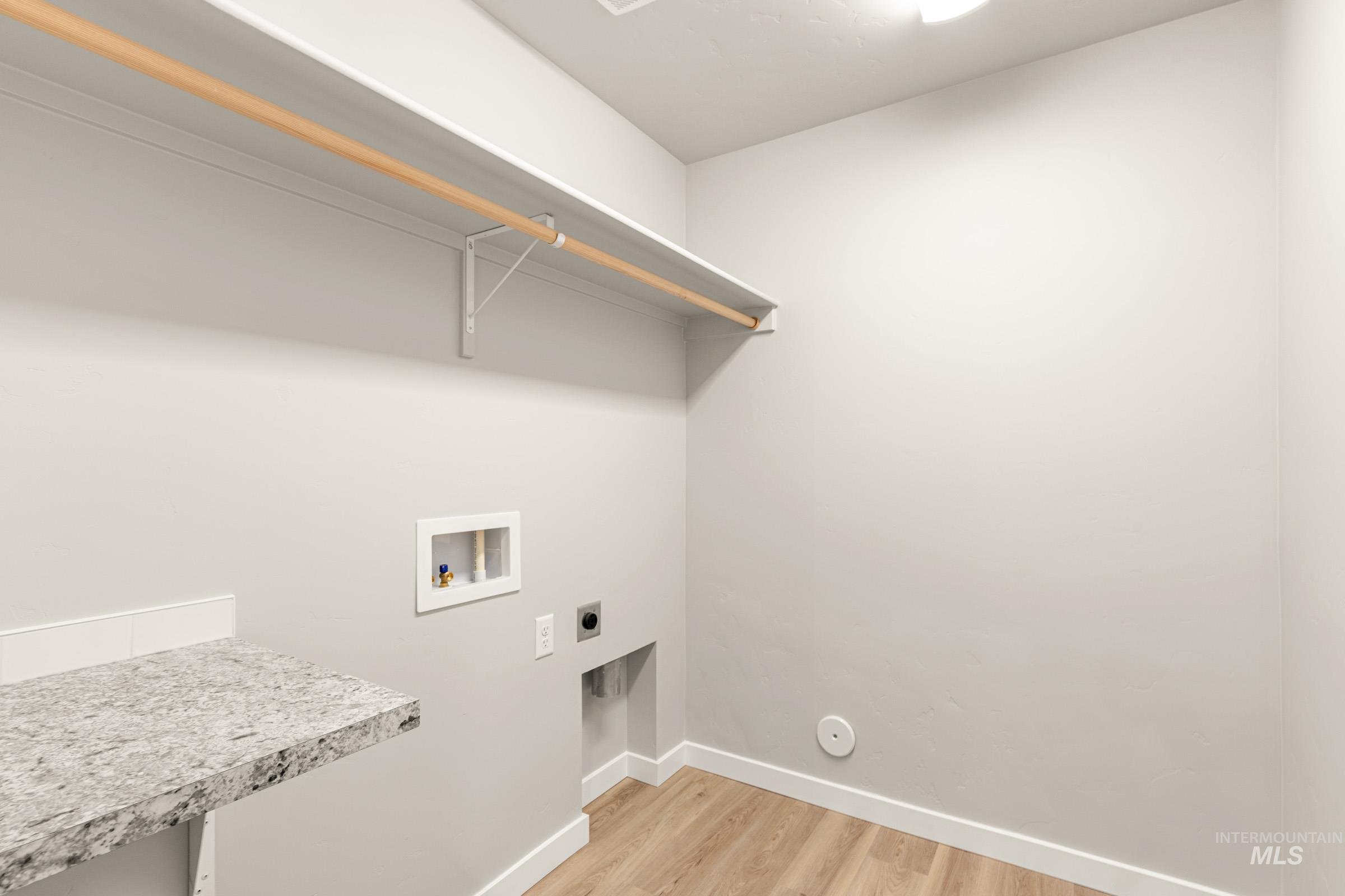 13686 Inman Court Caldwell, ID 83607 - Photo 11 of 20 Laundry room with light wood-style flooring, hookup for an electric dryer, and hookup for a washing machine