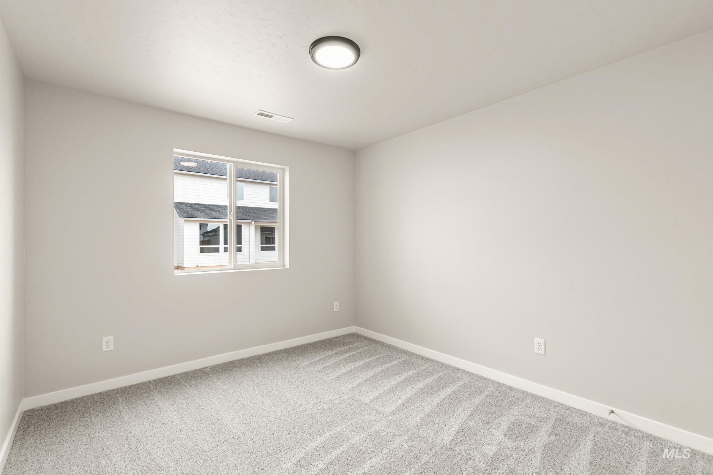 13686 Inman Court Caldwell, ID 83607 - Photo 12 of 20 Unfurnished room featuring baseboards and light colored carpet