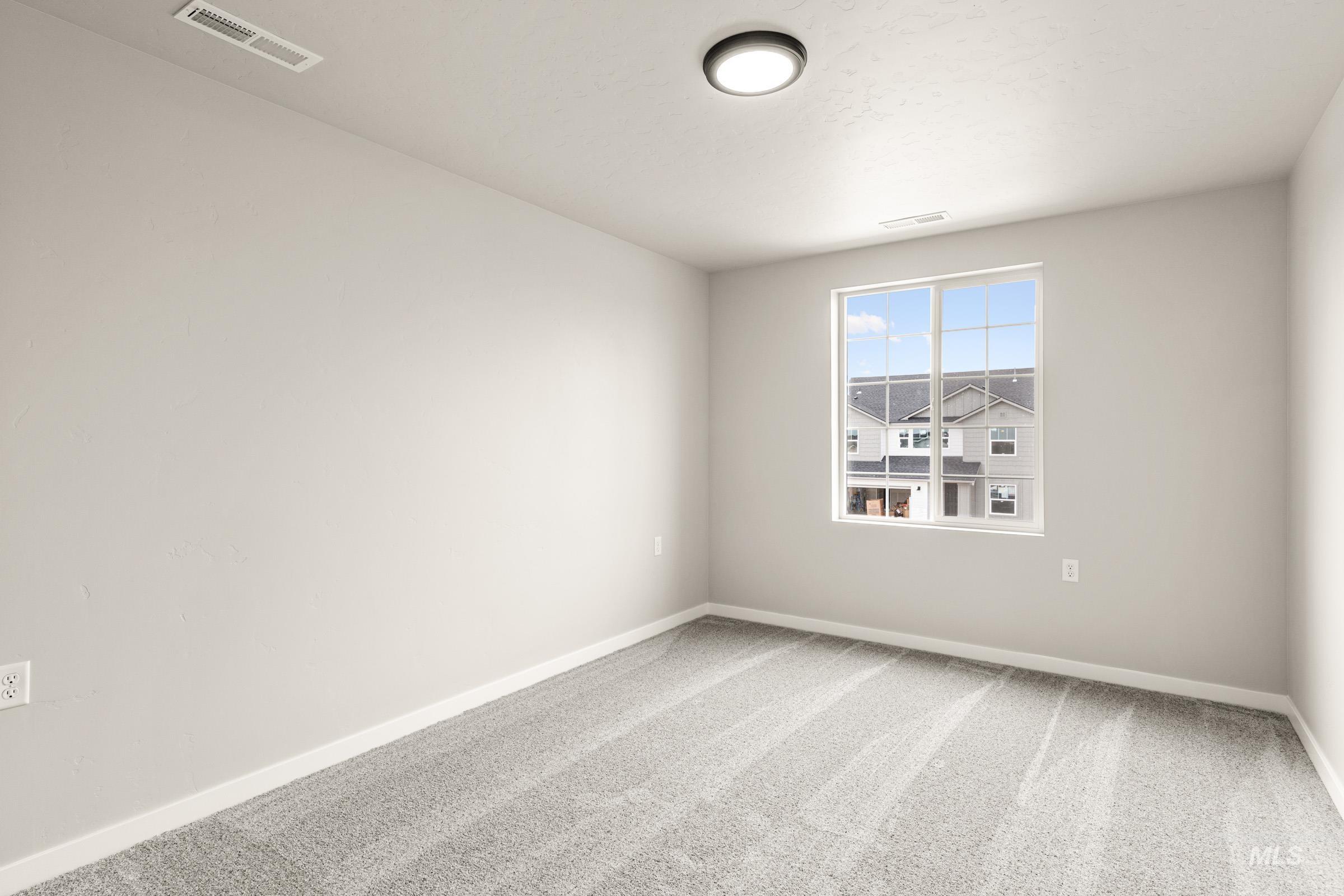 13686 Inman Court Caldwell, ID 83607 - Photo 13 of 20 Empty room featuring light colored carpet and baseboards