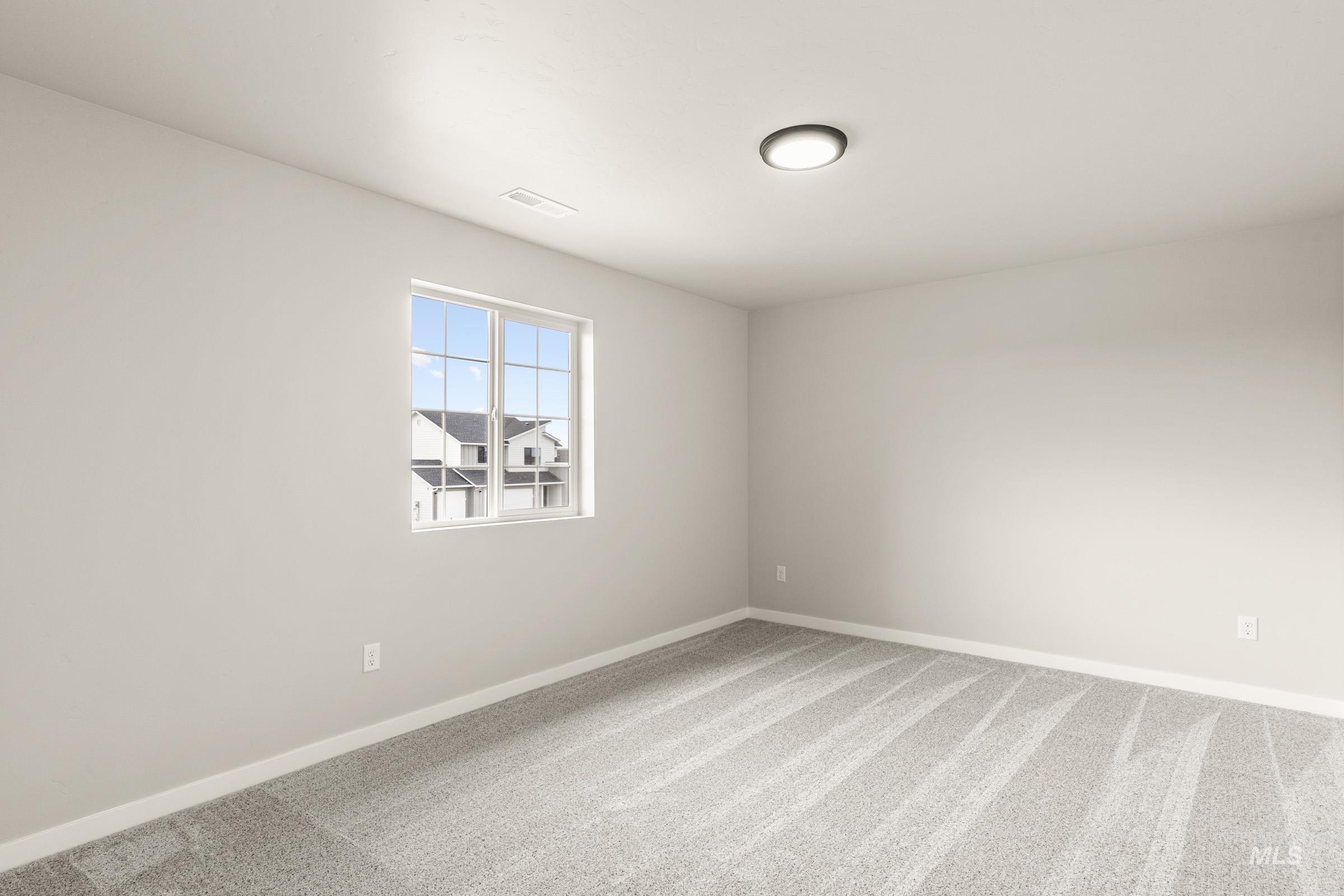 13686 Inman Court Caldwell, ID 83607 - Photo 14 of 20 Empty room with light colored carpet and baseboards