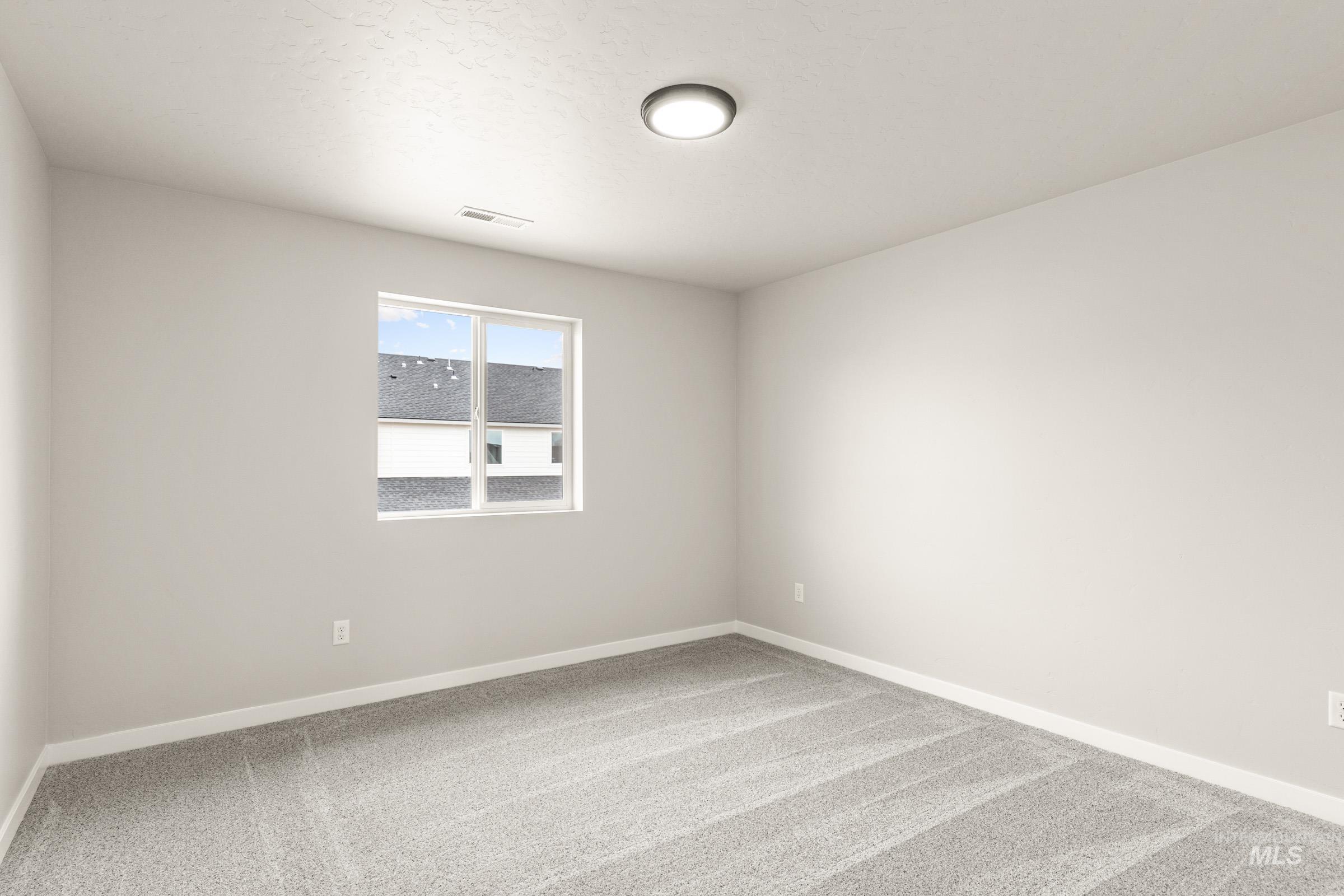 13686 Inman Court Caldwell, ID 83607 - Photo 17 of 20 Spare room with light carpet and baseboards