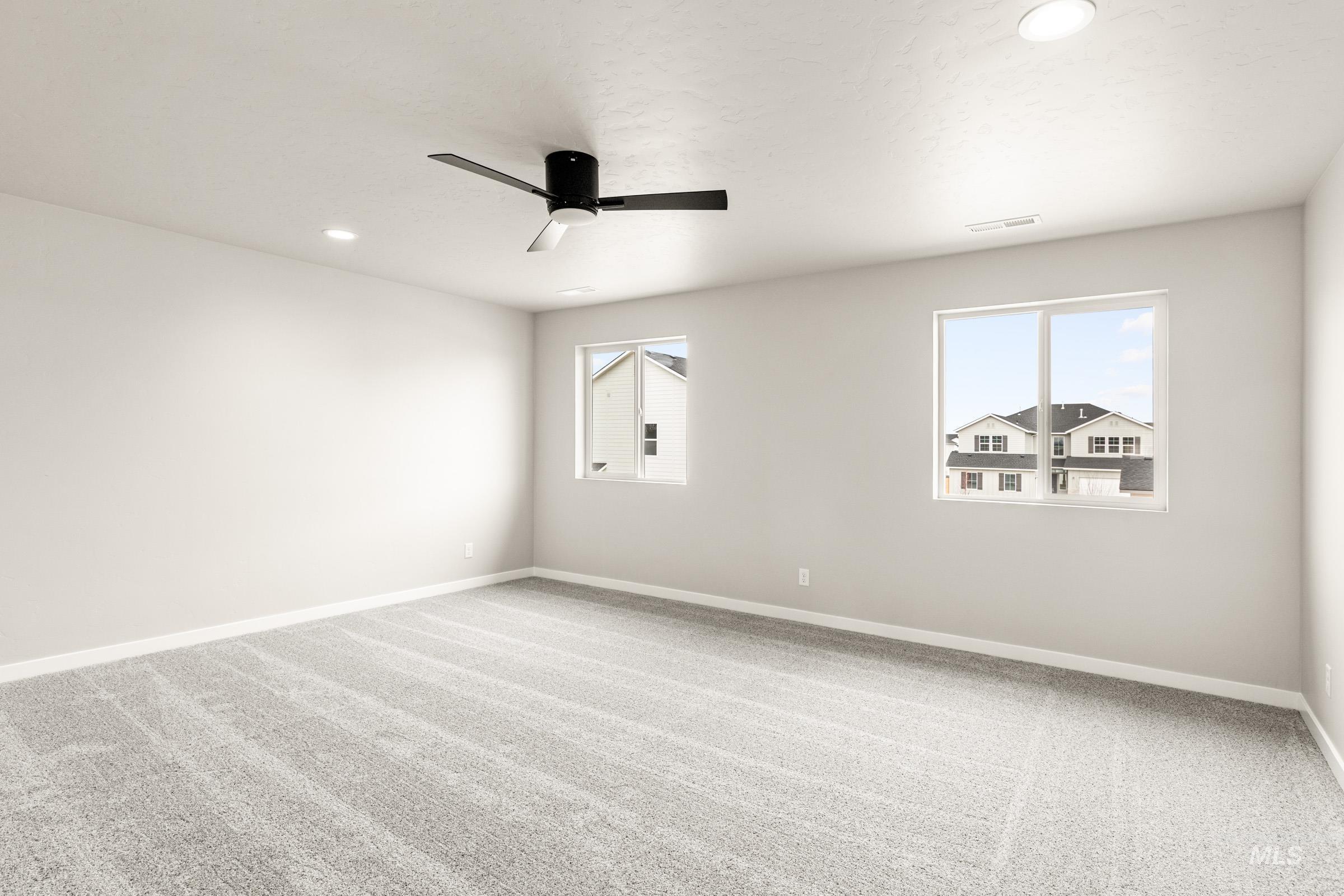 13686 Inman Court Caldwell, ID 83607 - Photo 18 of 20 Unfurnished room with light carpet, recessed lighting, and ceiling fan