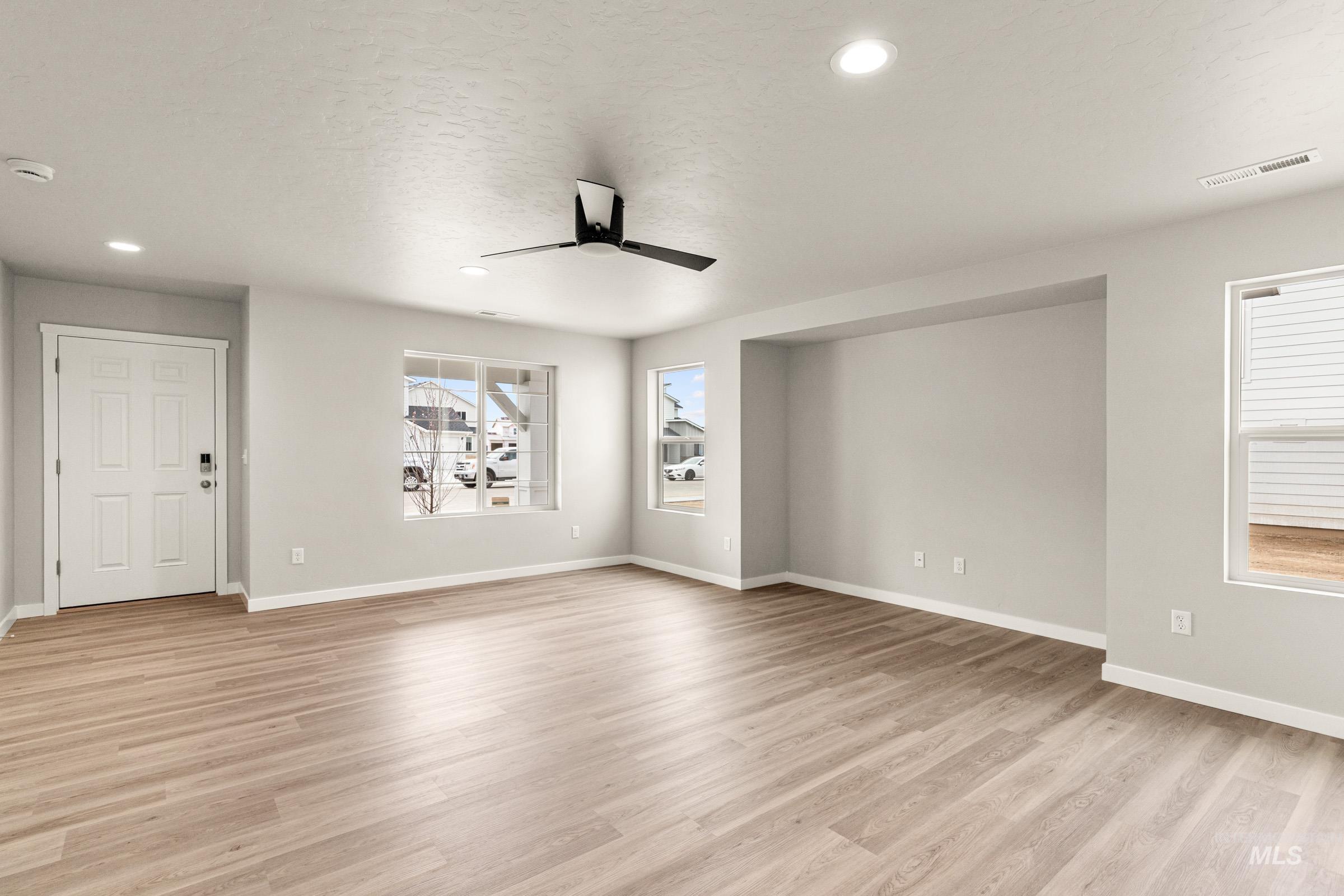 13686 Inman Court Caldwell, ID 83607 - Photo 10 of 20 Spare room with a ceiling fan, light wood finished floors, recessed lighting, and a textured ceiling