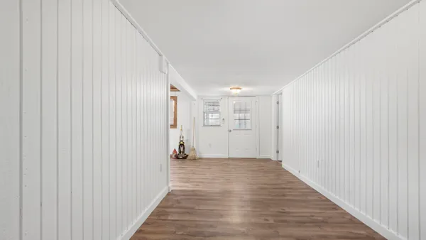 an empty room with a empty space and windows