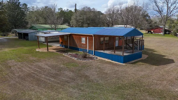 a view of a house with backyard and a slide