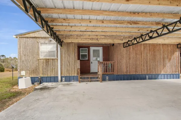 a view of a house with a yard and sitting area