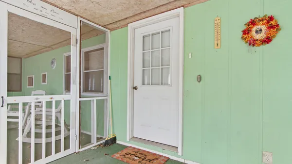 a view of front door with outdoor seating