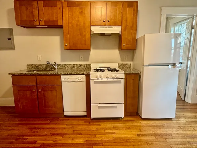 a white refrigerator freezer sitting inside of a kitchen