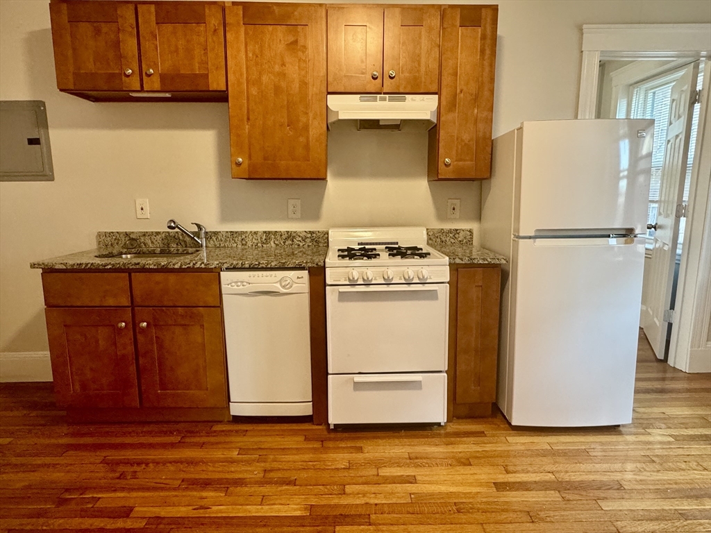 a white refrigerator freezer sitting inside of a kitchen