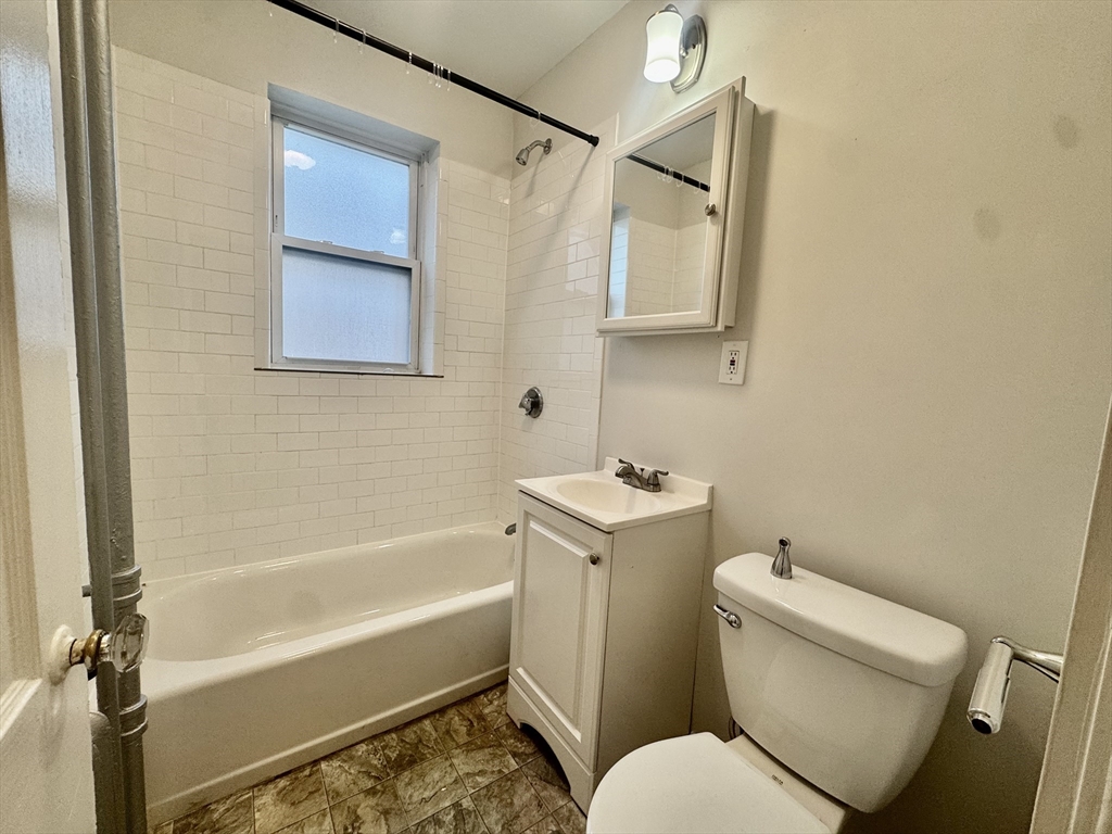 1615 Commonwealth Avenue, Unit 27 Boston, MA 02135 - Photo 6 of 10 a bathroom with a toilet sink and bathtub