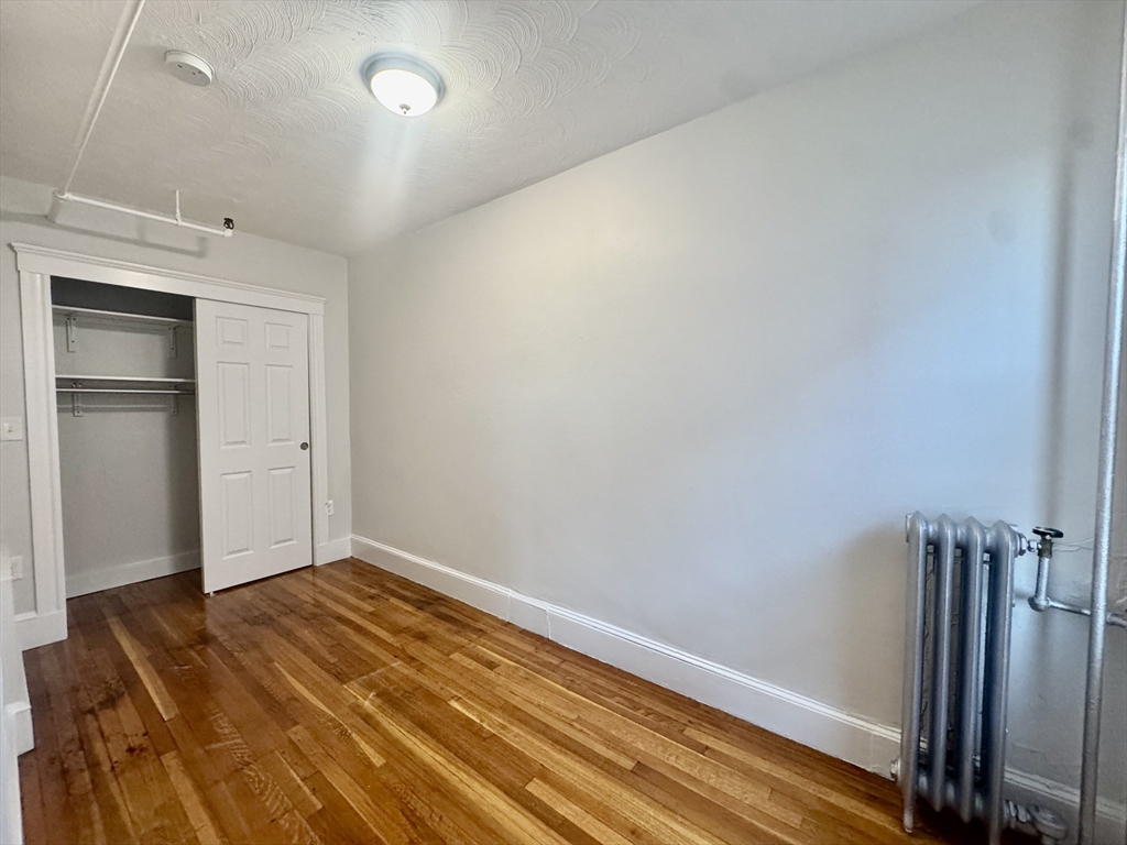 1615 Commonwealth Avenue, Unit 27 Boston, MA 02135 - Photo 7 of 10 a view of empty room with wooden floor