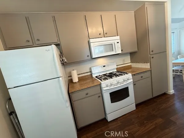 a white refrigerator freezer and a stove sitting inside of a kitchen