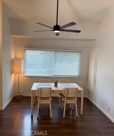 a dining room with furniture and wooden floor