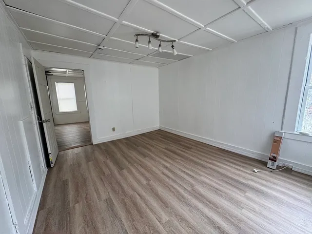 a view of a room with wooden floor